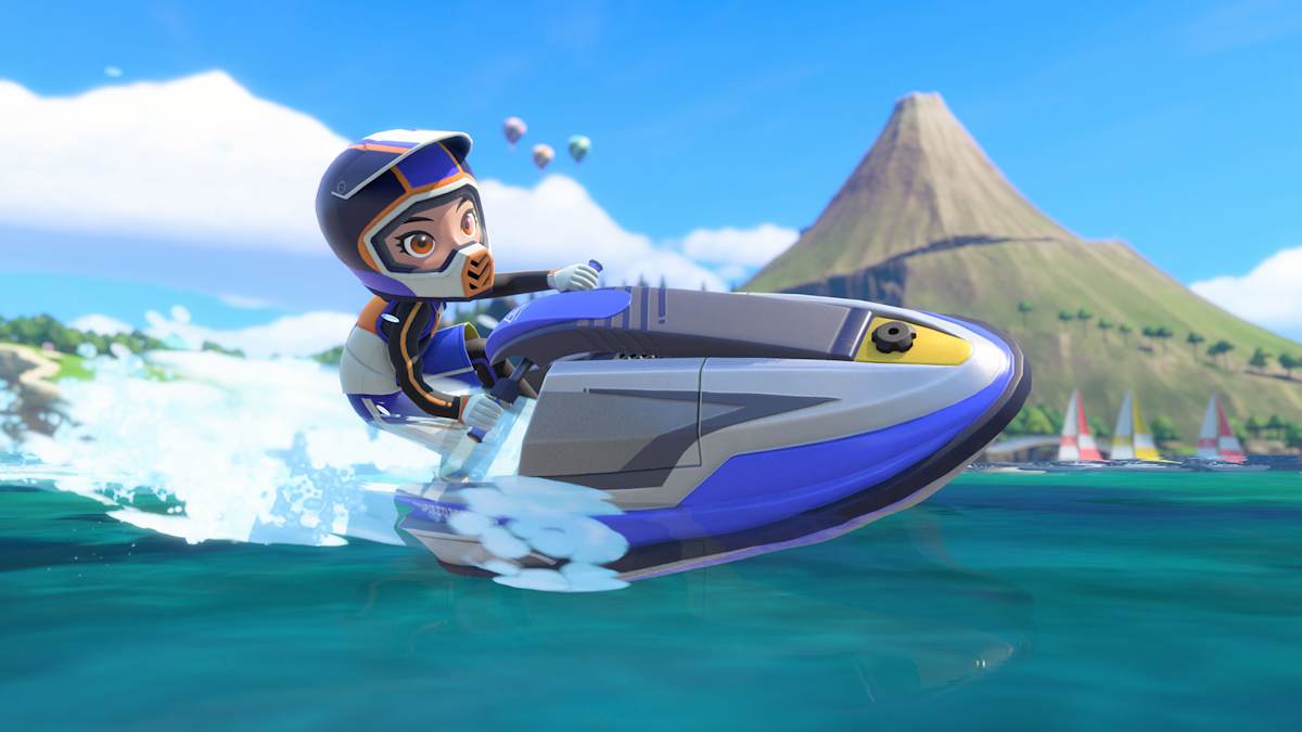 A rider in a helmet speeds across the water on a jet ski in power cruising, with Wuhu’s volcano and sailboats behind