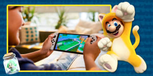 gamer playing Super Mario on OLED Switch on couch