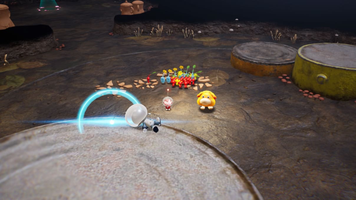 An Explorer, Oatchi, and a squad of Pikmin have discovered an unknown figure laying on the ground and wearing a space suit similar to the Explorer's own.