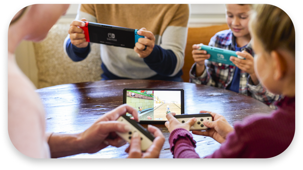 A family of four plays on various Nintendo Switch consoles