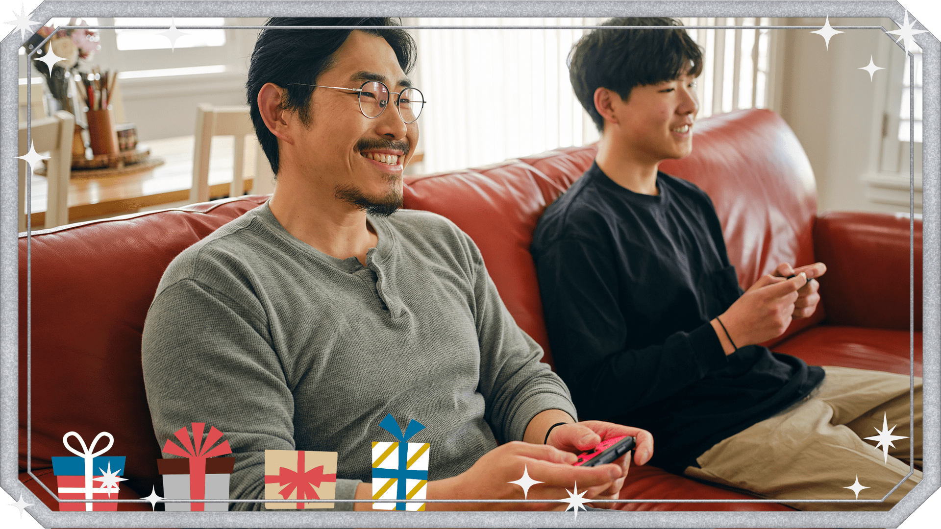 Dad and son playing Switch on couch together