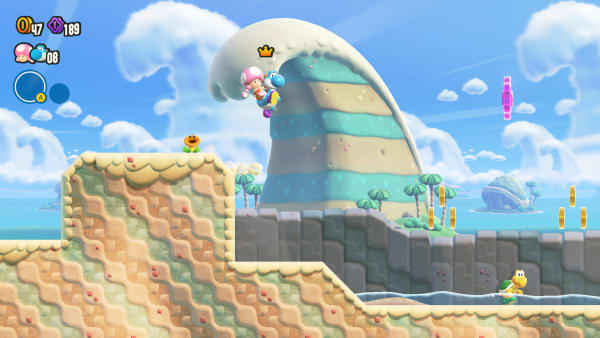 A blue Yoshi carries Toadette across a challenging course.